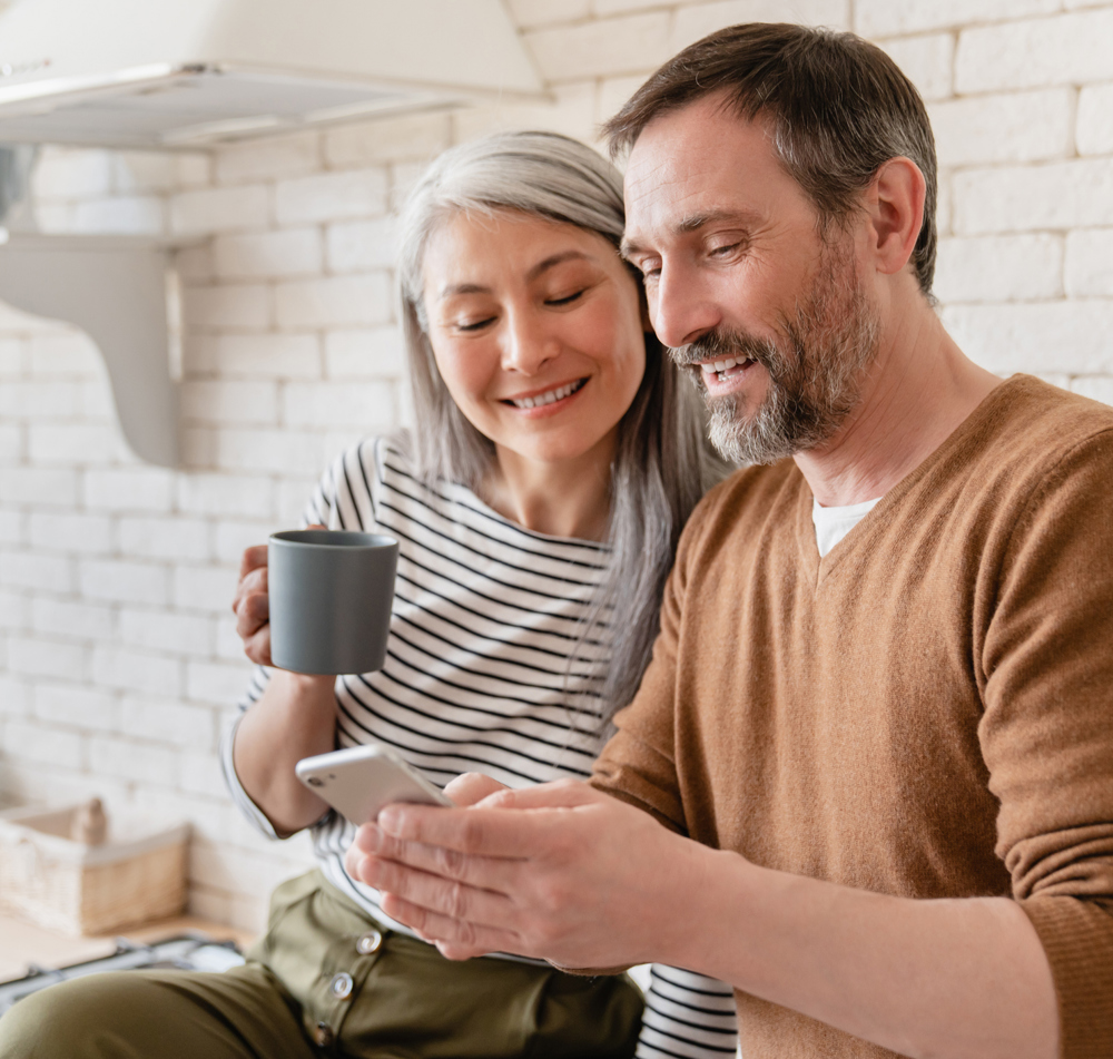 Man And Woman Smiling At Phone
